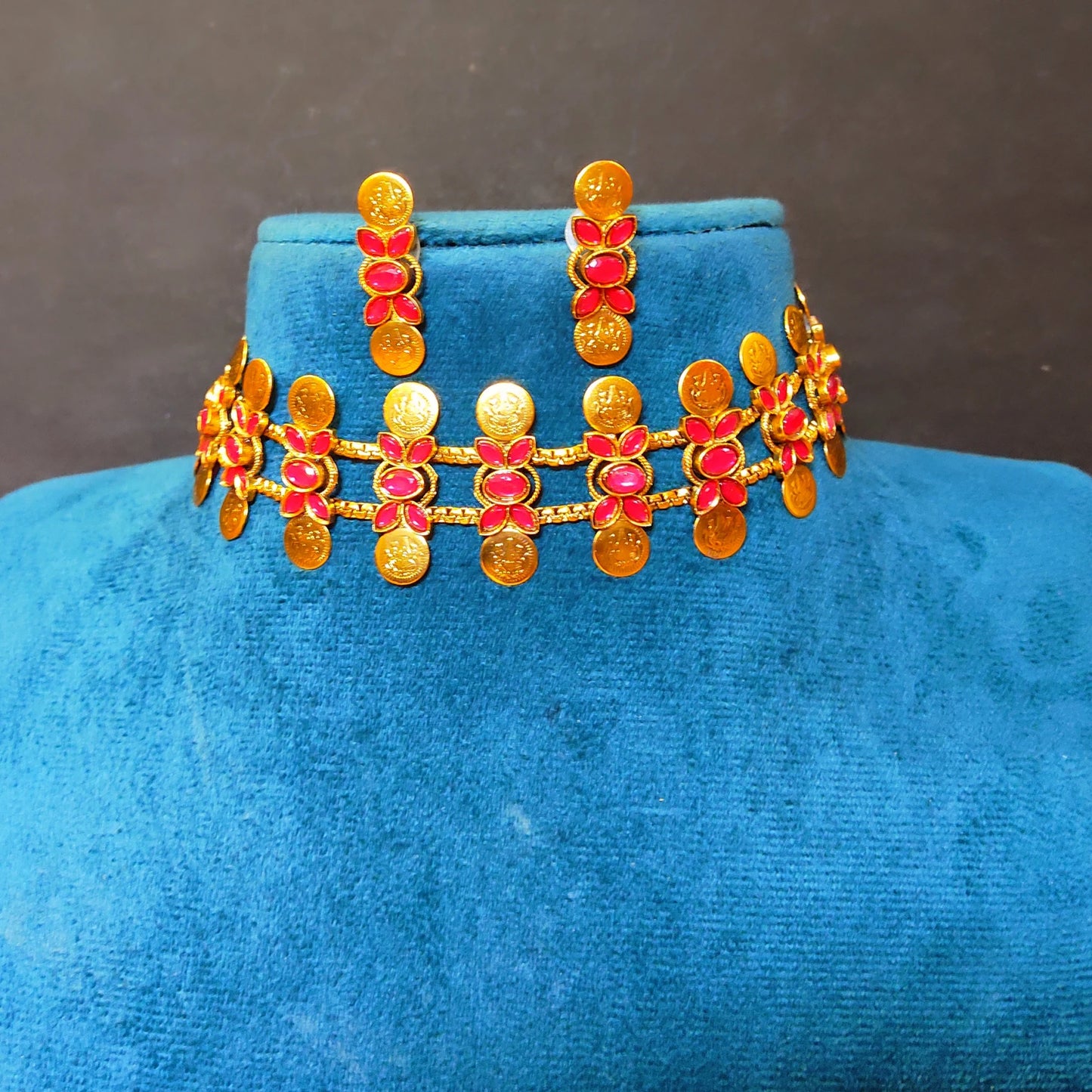 Traditional South Indian matte gold Kasu Mala coin choker necklace with ruby stone accents and matching stud earrings,