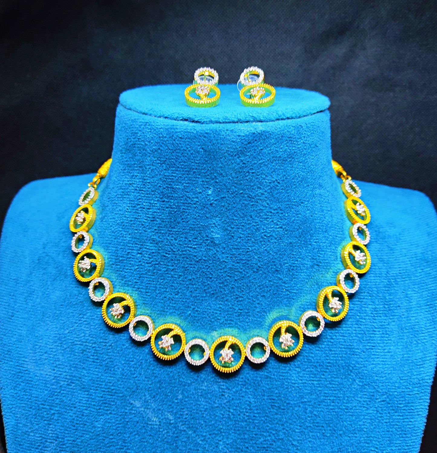 Jewelry set with necklace and earrings on a blue mannequin
