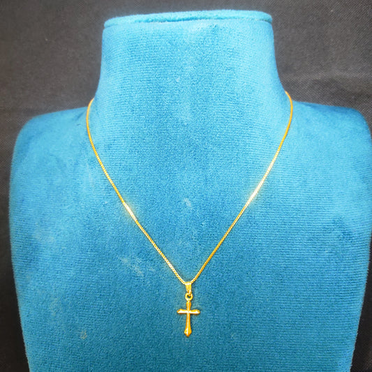 Gold plated neckchain with a sacred pendant on a blue velvet mannequin bust.