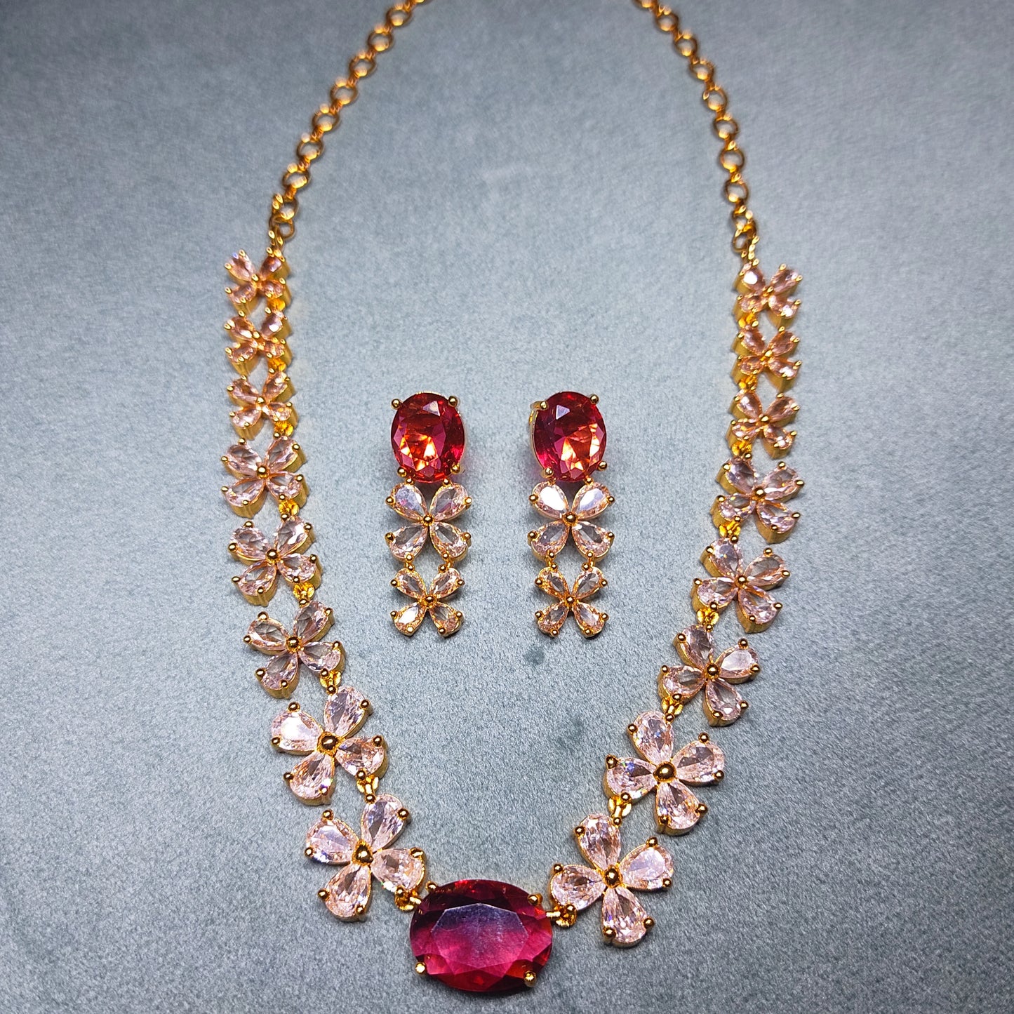 Gold Plated Jewelry set with necklace and earrings on a gray background