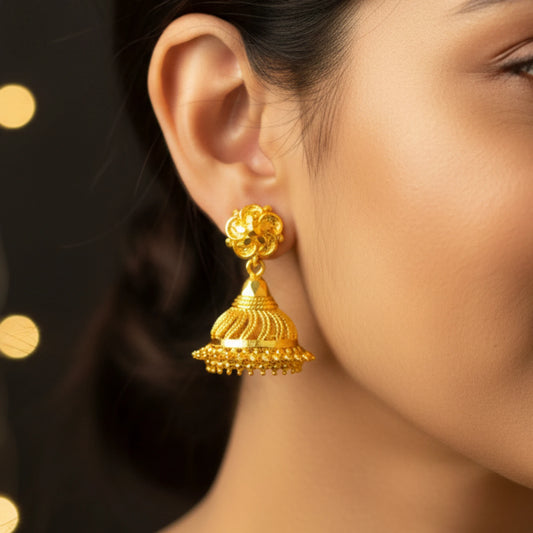 Close-up of a woman wearing a gold plated Jimikki/Jhumka earring with a blurred background
