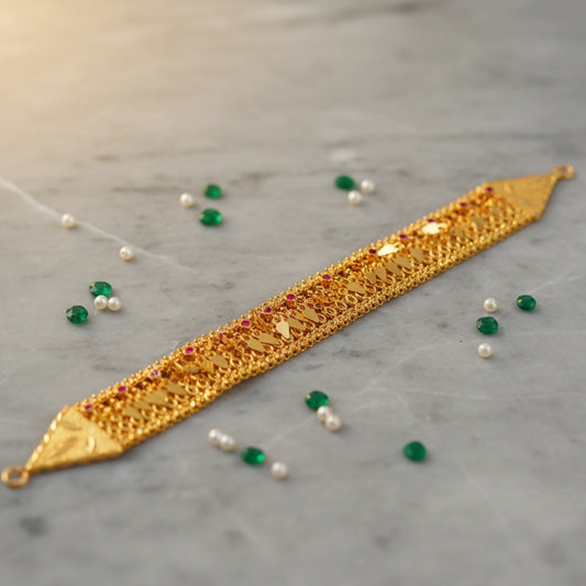 Gold plated kerala elakka thali choker on a gray surface