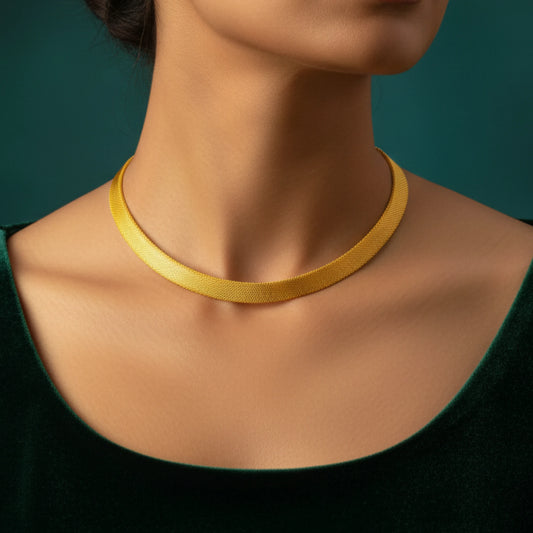 Traditional Kerala Kasavu inspired gold-plated necklace on a woman's neck in a green background