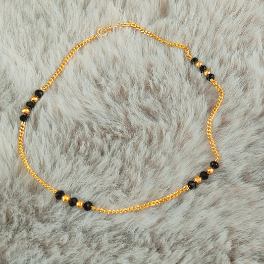 Gold plated Anklets with Nazariya black beads on a fur background