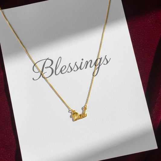 Gold plated neck chain with Dad written on pendant in maroon background