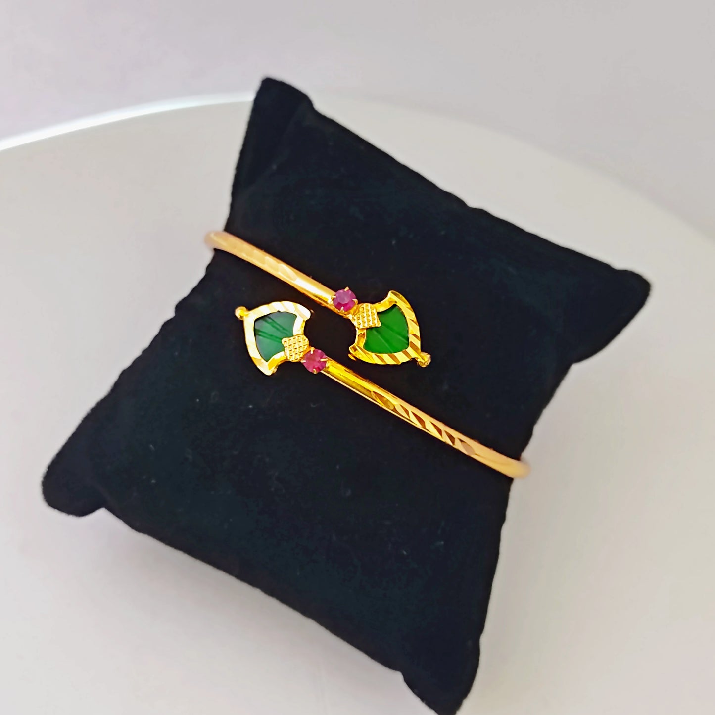 Gold plated Cuff/Torque/Bracelet with green palakka on a cushion