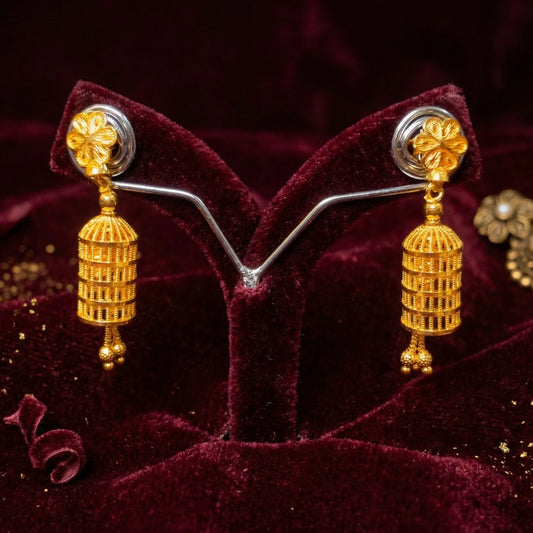 Gold plated Lantern Style Jimikki/Jhumka earrings on a red velvet stand with a dark background