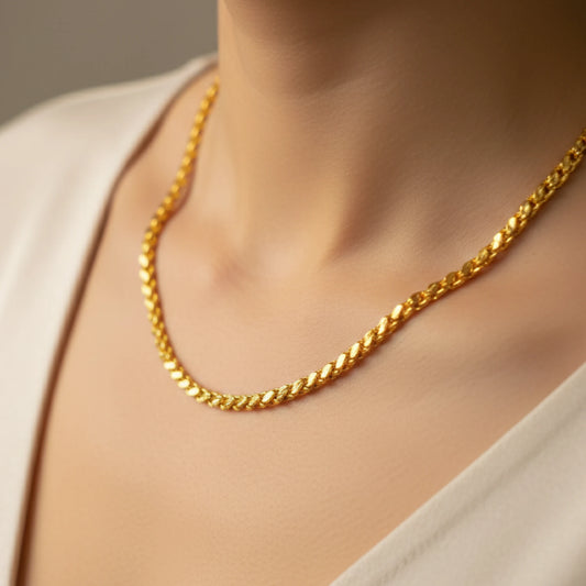 Gold plated neck chain with wheat link pattern with a neutral background