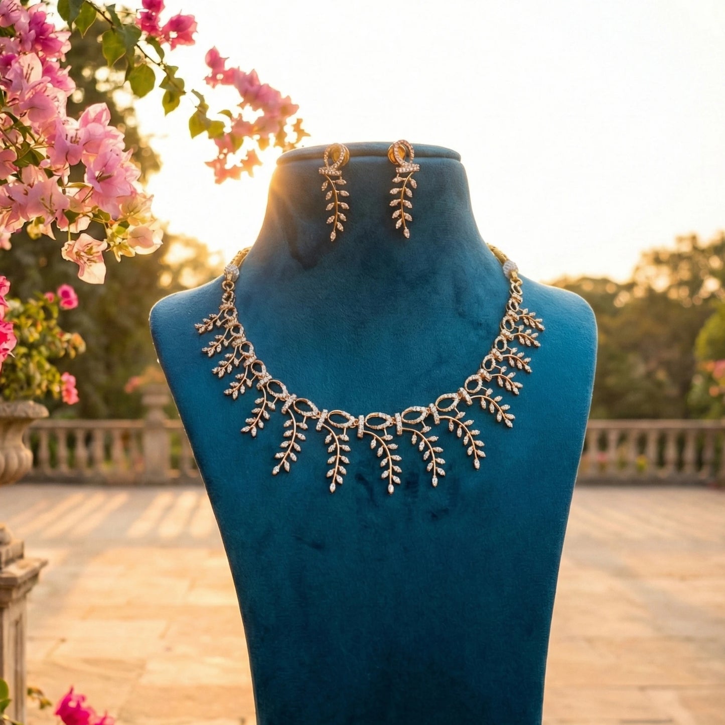 Necklace set on a blue mannequin with flowers in the background