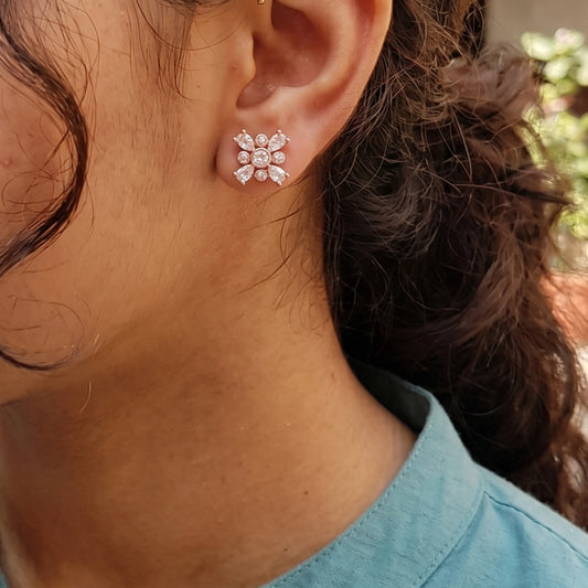 Rose gold flower stud earrings with marquise cut stones on a Girl