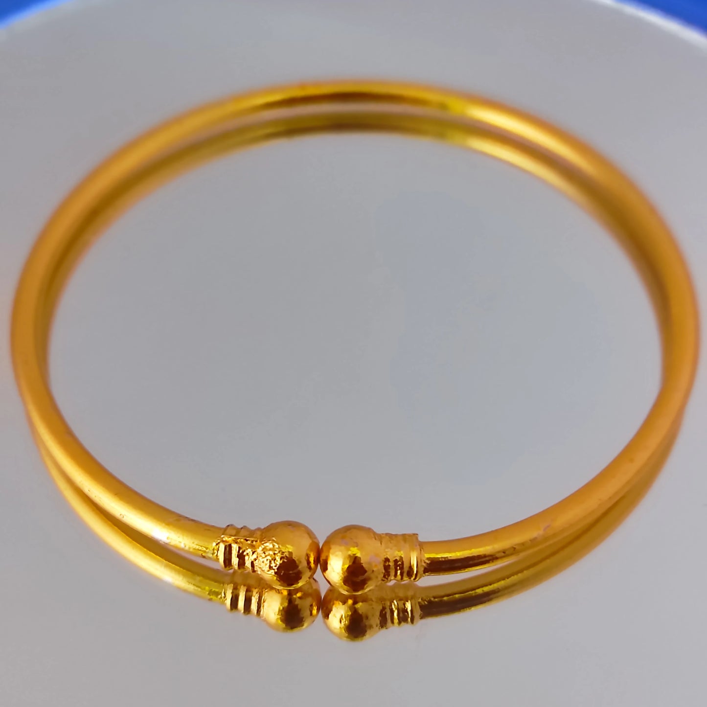 Gold plated bracelet with a plain background