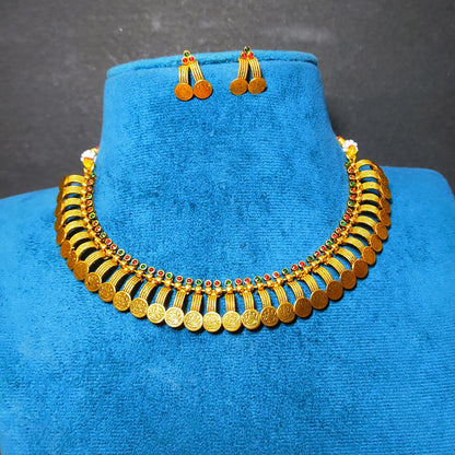 Antique Gold Finish coin necklace and matching drop earrings displayed on a blue velvet jewelry bust against a dark gray background.