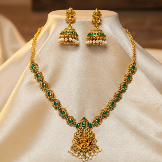 antique gold finish lakshmi pendant necklace with green stones