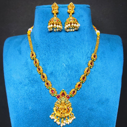 antique gold finish lakshmi pendant necklace with multicolor stones in a mannequin