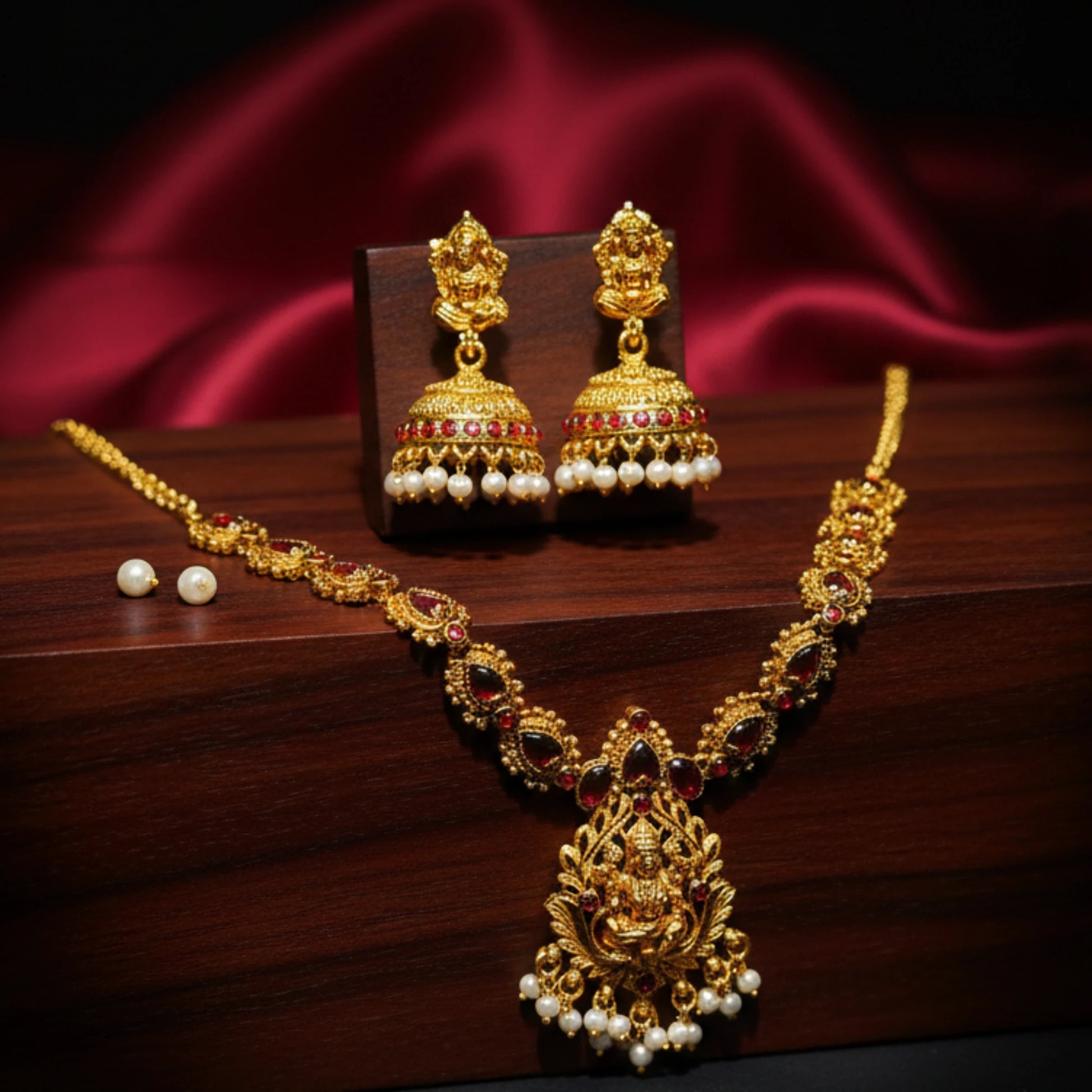 antique gold finish lakshmi pendant necklace with red stones