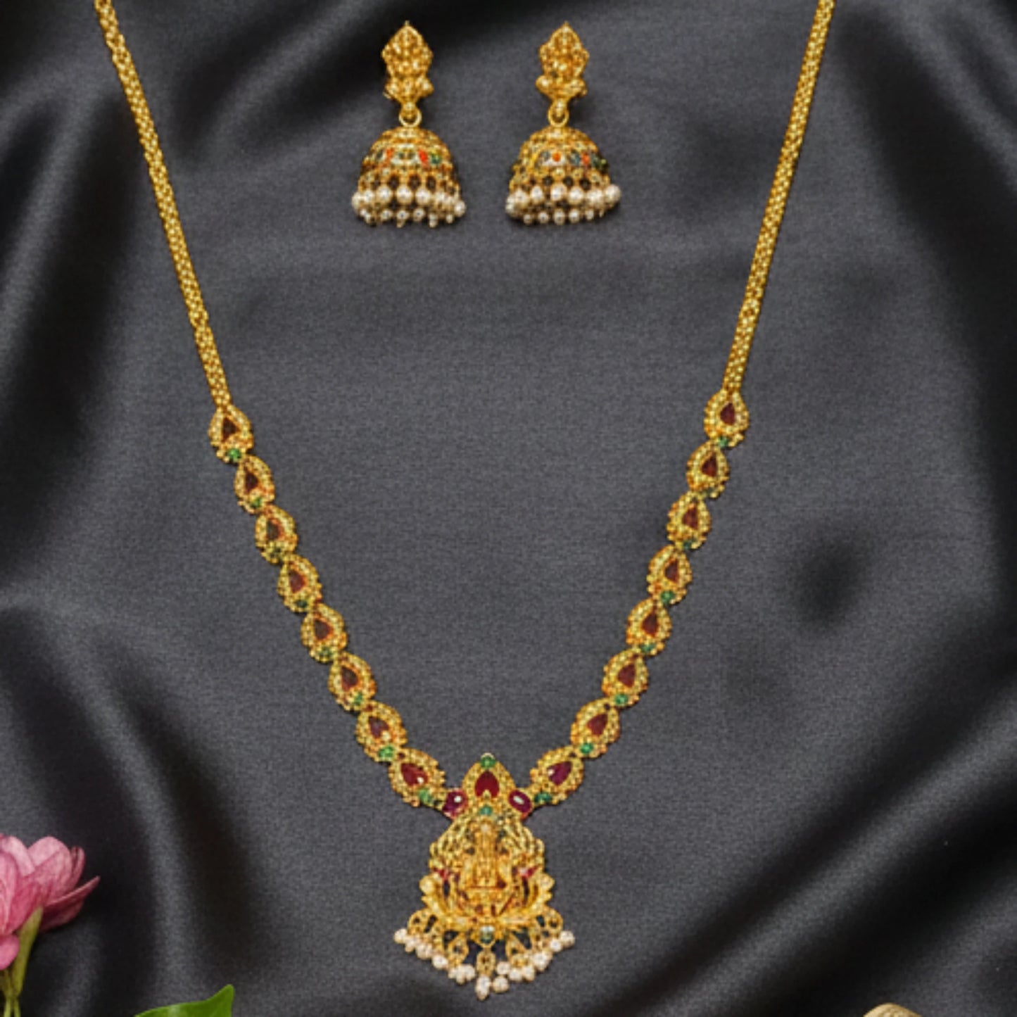 antique gold finish lakshmi pendant necklace with multicolor stones in a closeup shot