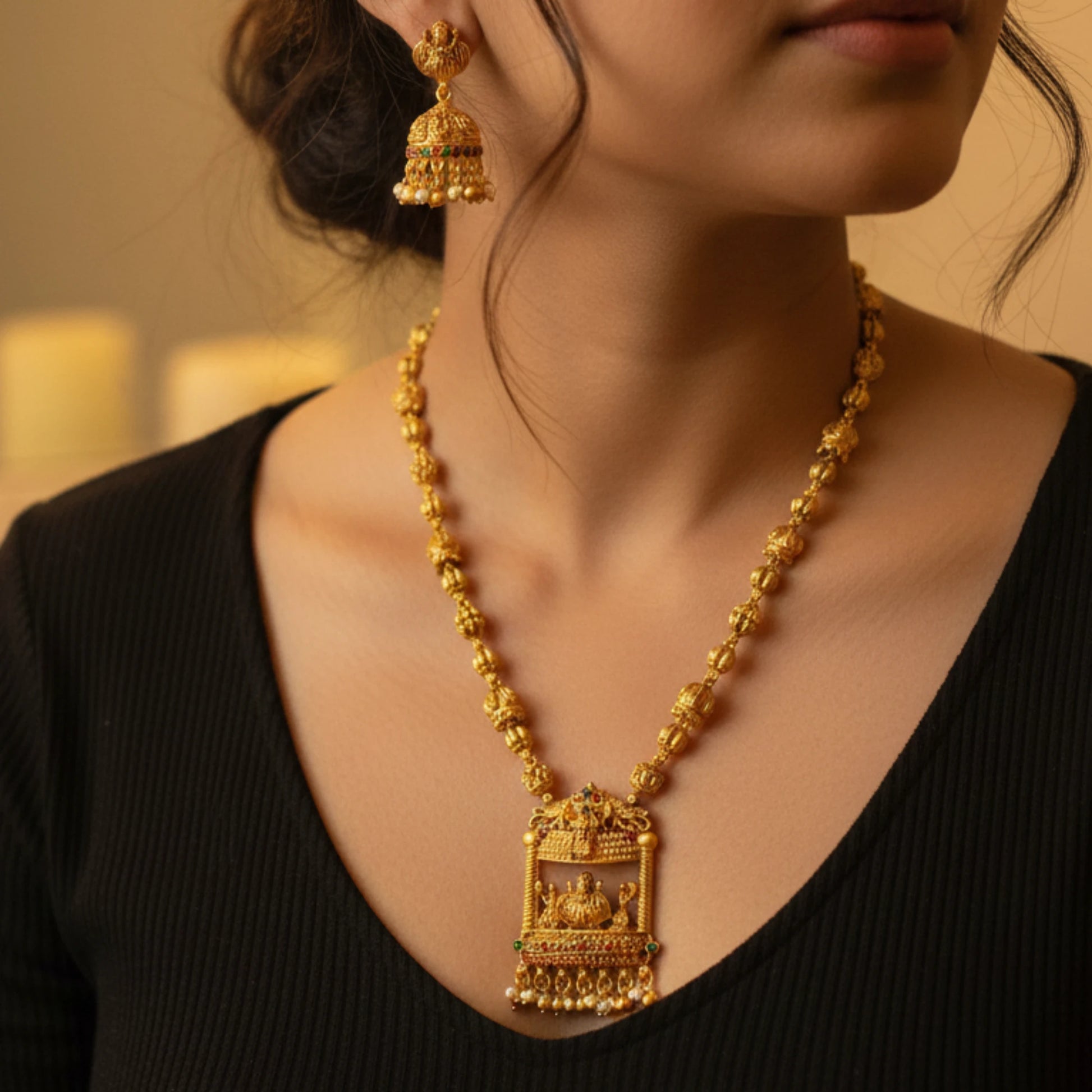 antique gold finish lakshmi pendant haram with matching earrings on a model