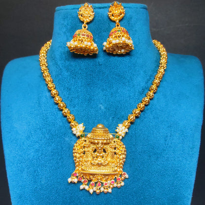 Antique Gold finish necklace and earrings set on a blue stand