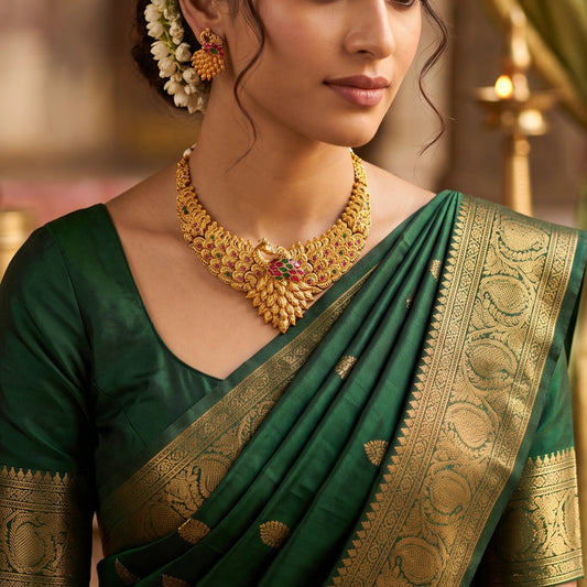 Traditional Indian matte antique gold peacock choker necklace and matching statement stud earrings beautifully worn by a model