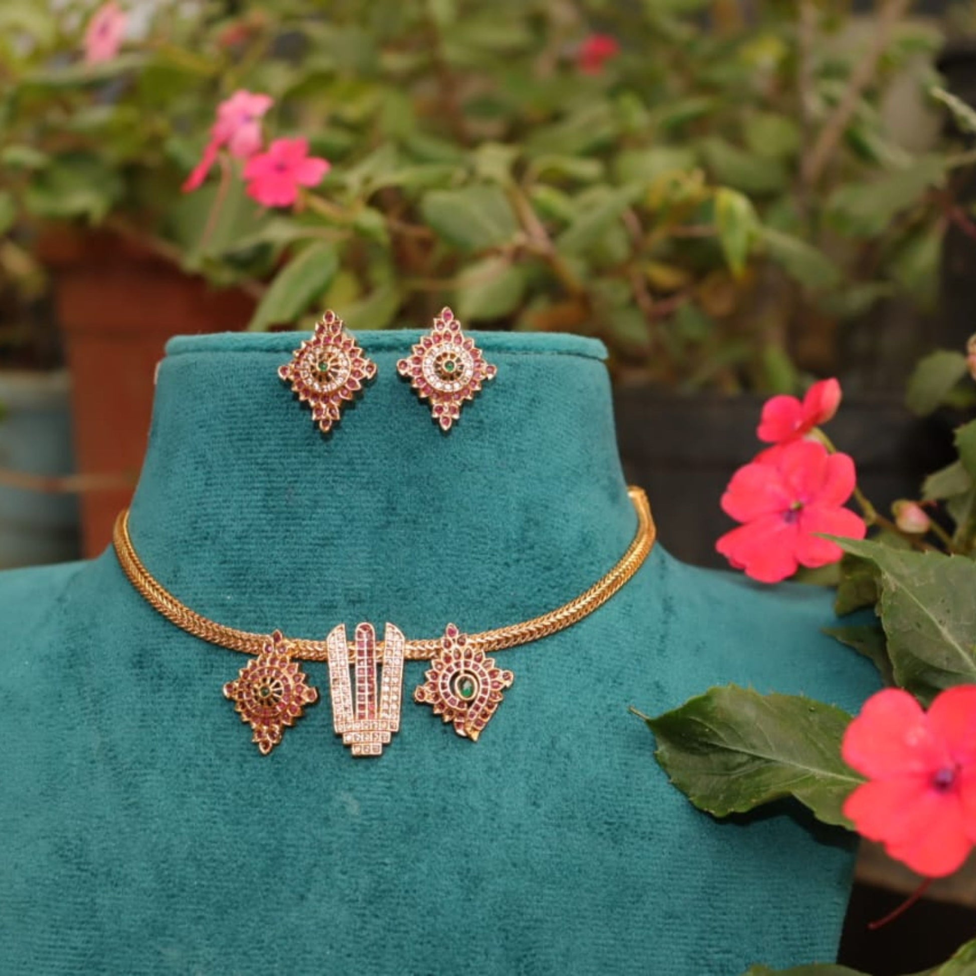 Jewelry set on a green mannequin with flowers in the background