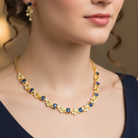 Close-up of a woman Gold plated necklace with blue gemstones and matching earrings