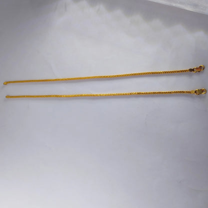 Two gold plated Anklet chains on a white background