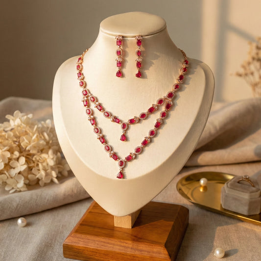 Red AD Stoned beaded necklace and earrings on a mannequin bust with a soft background