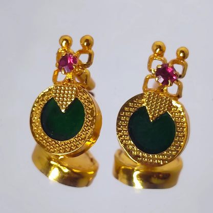 Pair of gold plated earrings with green palakka and ruby red stones on a white background