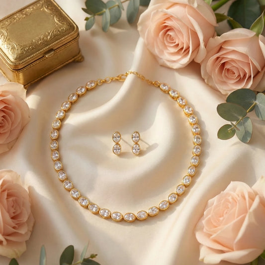 AD White Gold plated necklace and earrings with pink roses on a beige surface