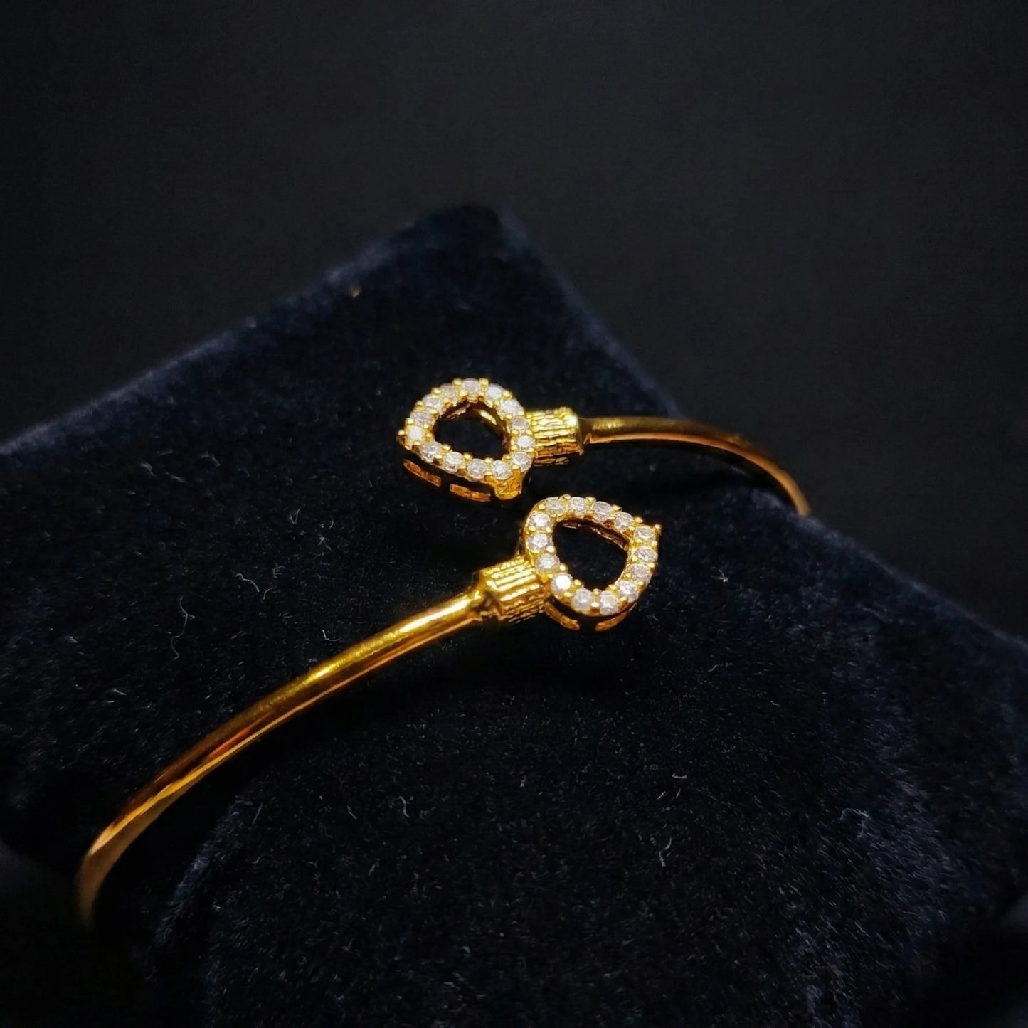 Gold plated Bracelet with diamond accents on a black cushion