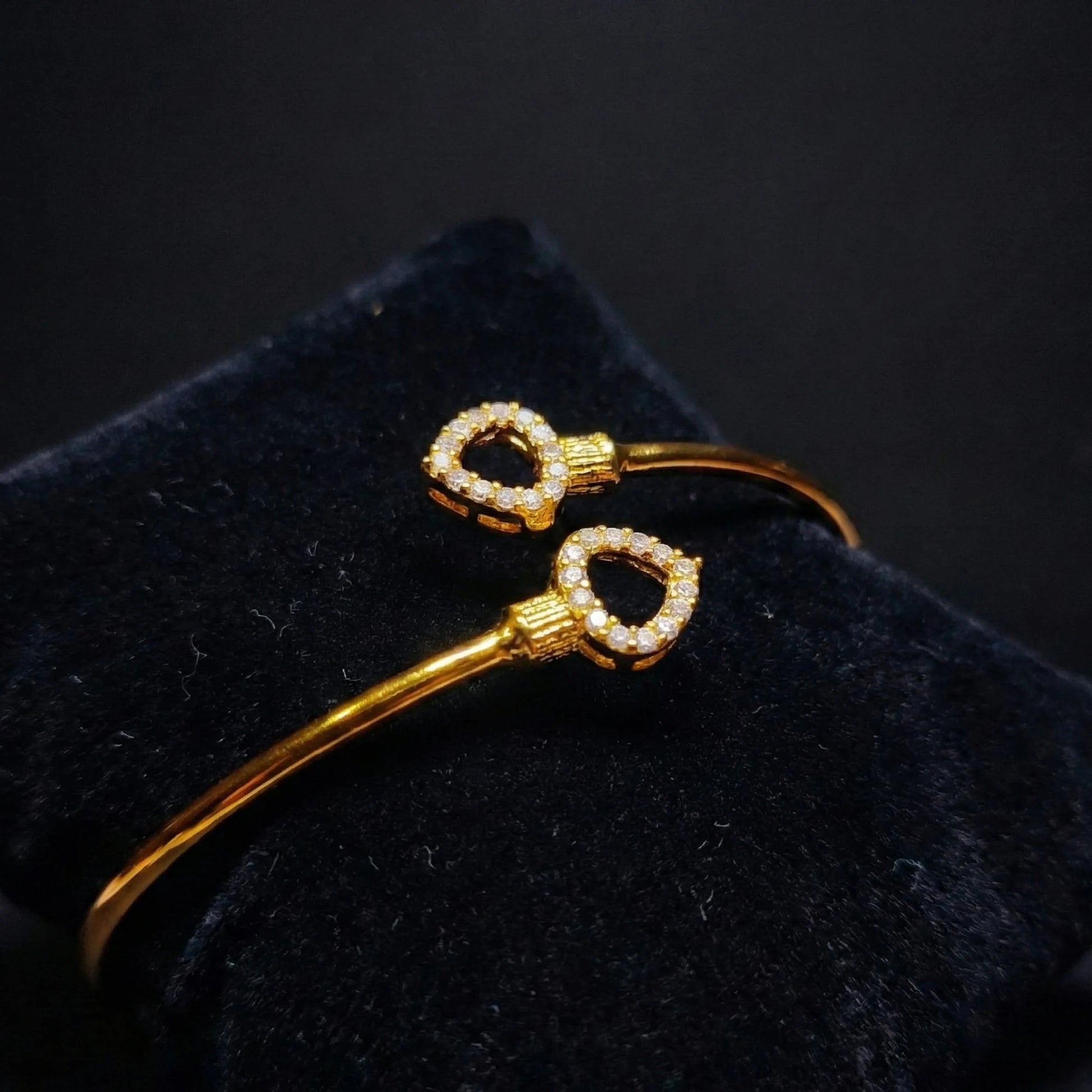 Gold plated Bracelet with diamond accents on a black cushion