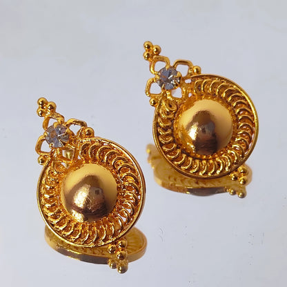 Pair of gold plated dome stud earrings with intricate designs on a light gray background
