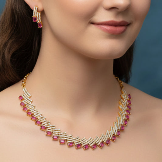Woman wearing a gold plated White and pink gemstone necklace with matching earrings against a blue background