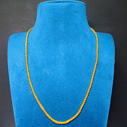 Gold Plated necklace on a blue velvet mannequin bust against a black background