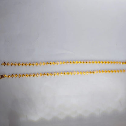 Gold plated delicate lace design anklets on a light gray background
