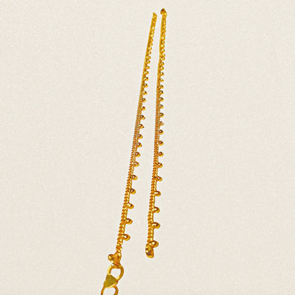 Gold plated Anklets on a beige background