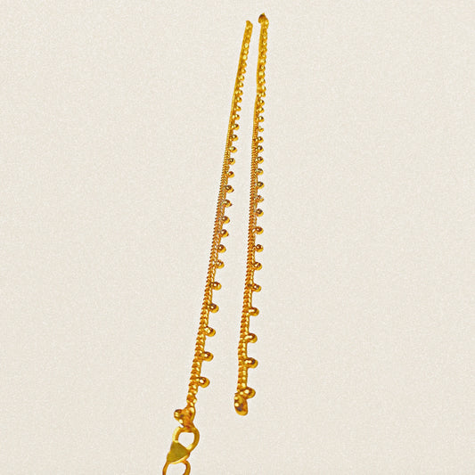 Gold plated Anklets on a beige background