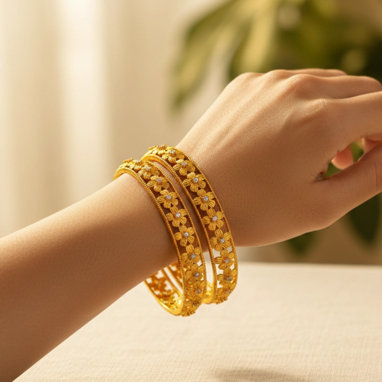 Gold plated Bangles on a wrist with a blurred background