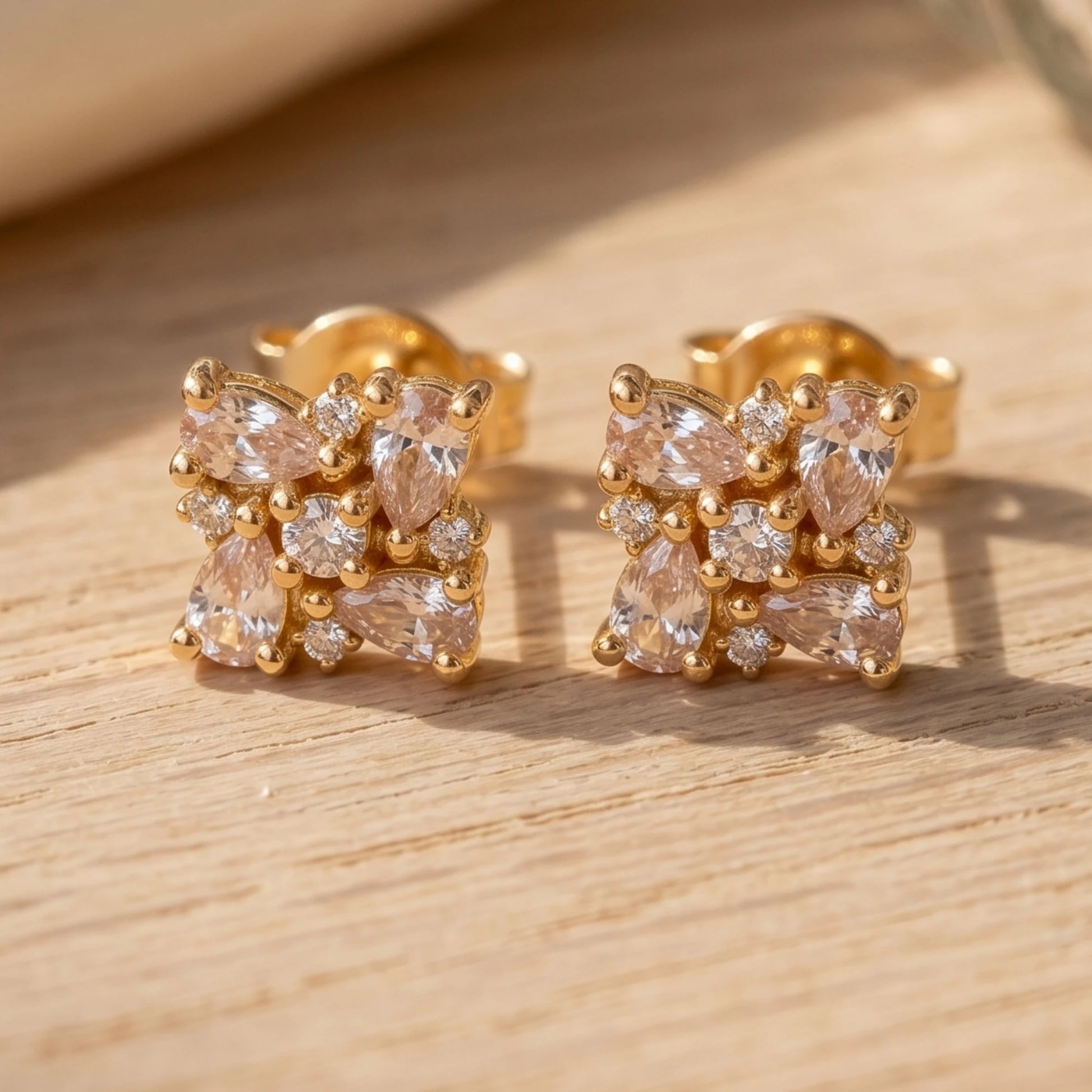 A Gold plated floral cluster earrings with Ad stones both in tear shaped and round shaped pattern arranged in a intricate manner