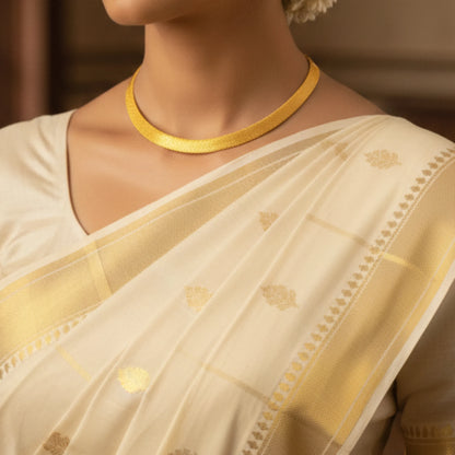 Traditional Kerala Kasavu inspired gold-plated necklace on a beige aesthetic background