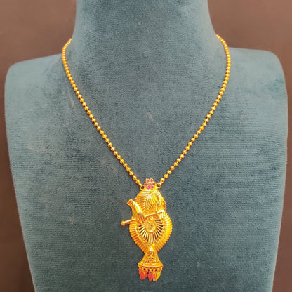 Gold plated necklace with Krishna with Flute pendant on a green mannequin bust