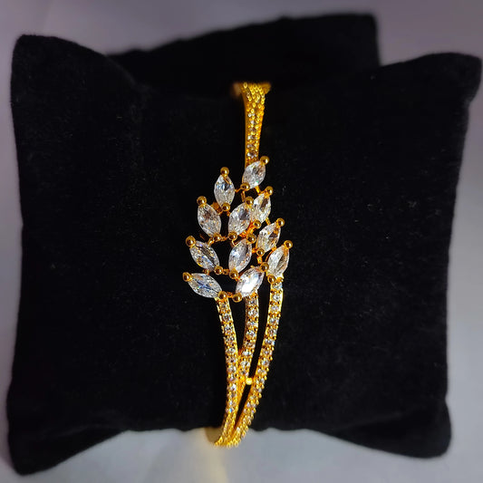 Gold plated AD Cuff on a black cushion