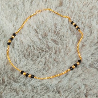 Gold plated Anklets with Nazariya black beads on a fur background
