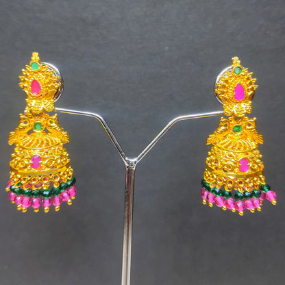 Gold plated Peacock Motif jimikki/Jhumka earrings with pink and green accents on a gray background