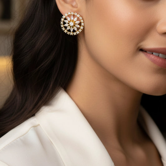 Close-up of a woman wearing a gold plated marquise crystal floral stud earring.