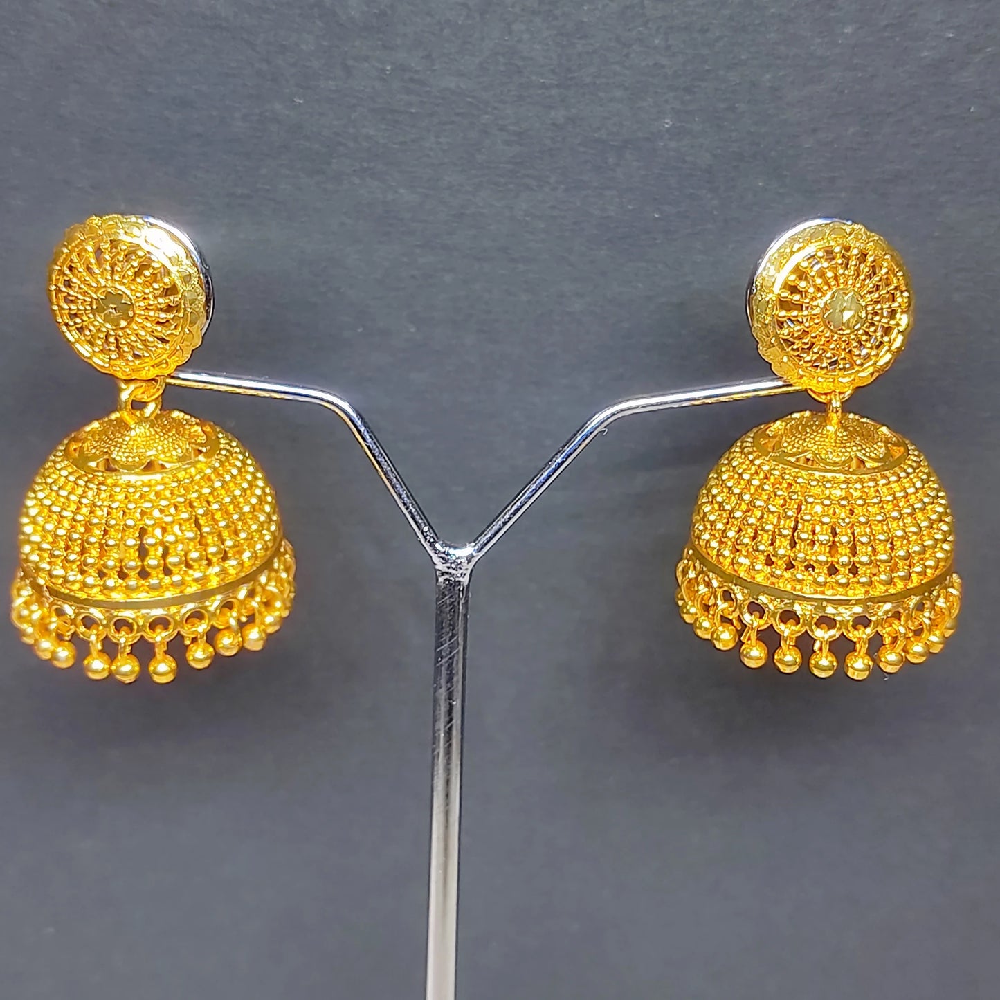 Gold plated Traditional Classic Bell Jimikki/Jhumka earrings on a gray background