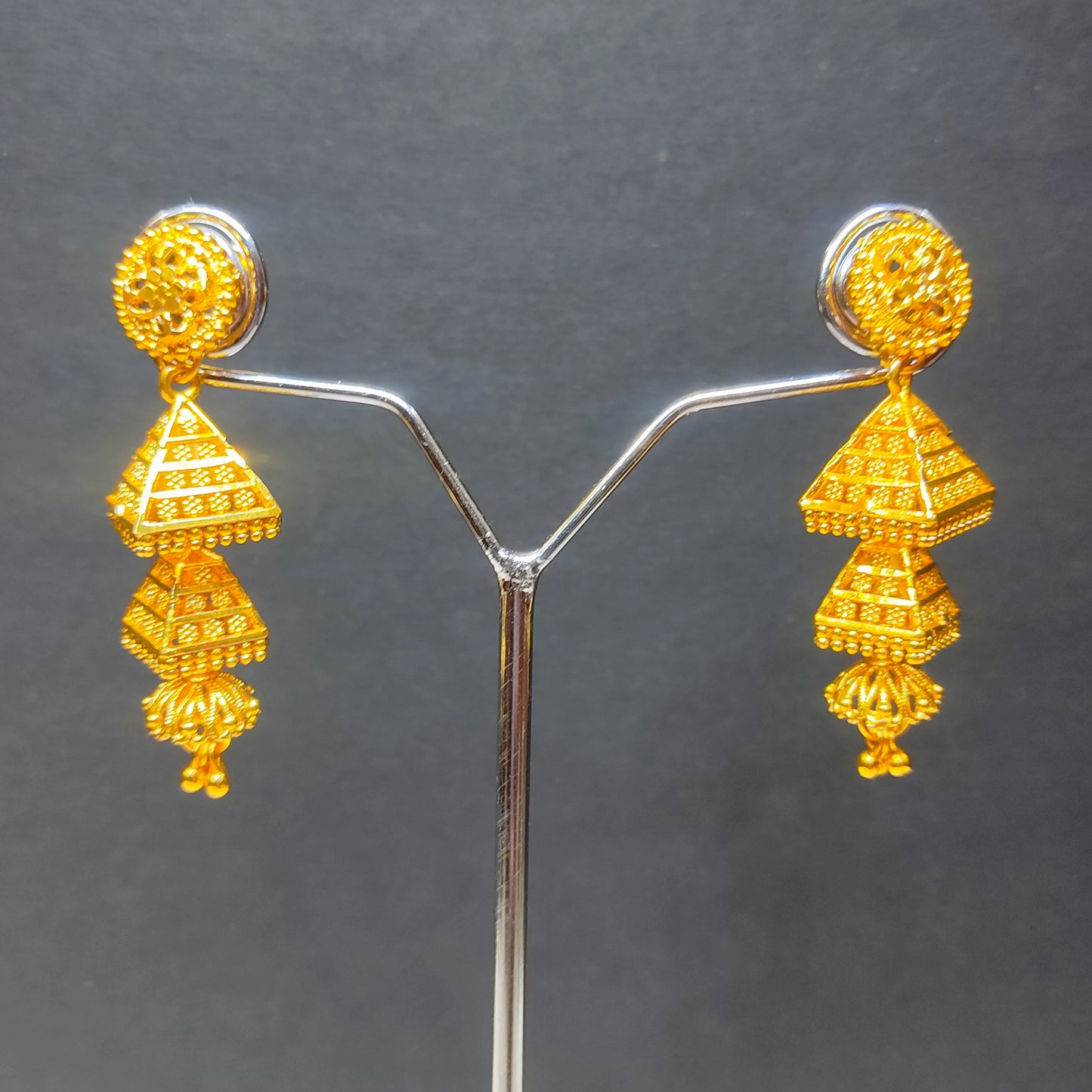 Gold plated 3 tier Jimikki/Jhumka earrings on a gray background