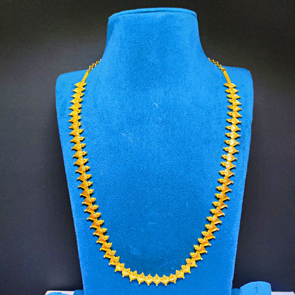 Gold plated necklace on a blue mannequin bust against a black background