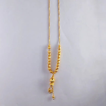 Gold plated necklace with beads on a light gray background