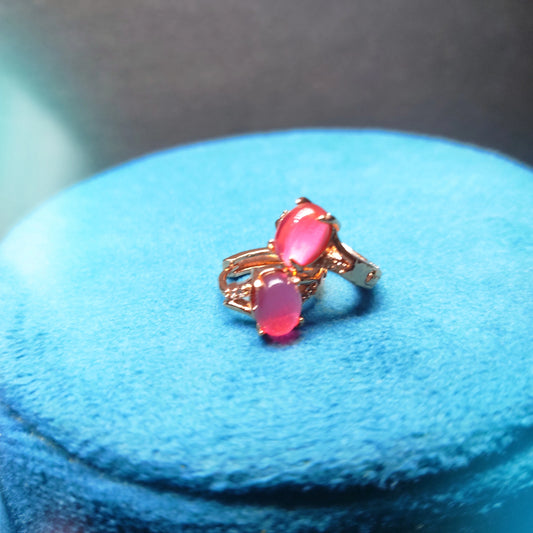 Rose Gold Earring with pink gemstones on a blue cushion